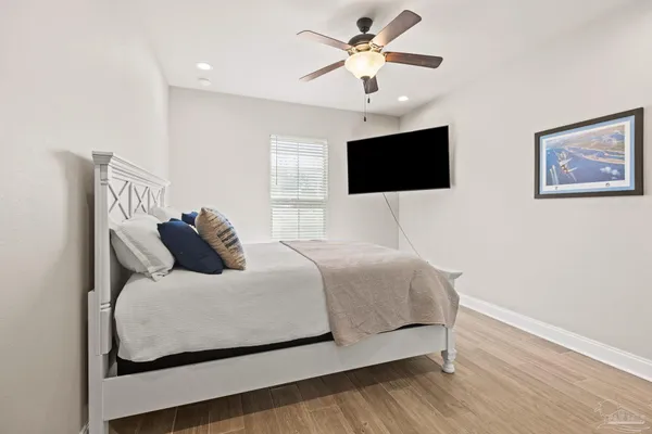 a bedroom with a bed and wooden floor