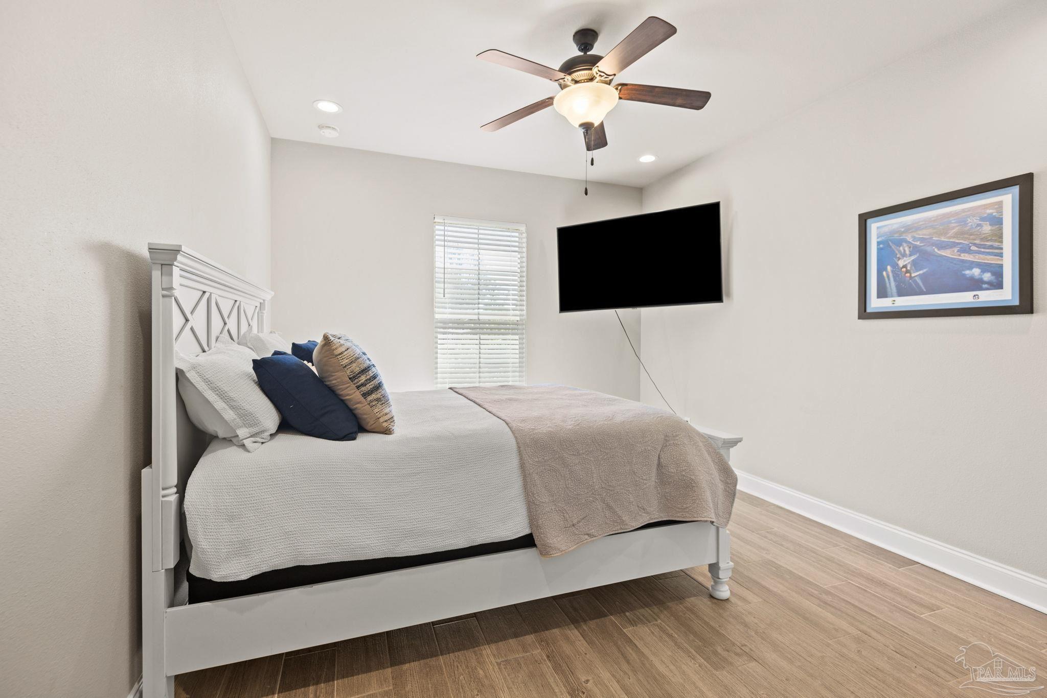 5912 Walter Franklin Road Pensacola, FL 32526 - Photo 33 of 51 a bedroom with a large bed and a flat screen tv