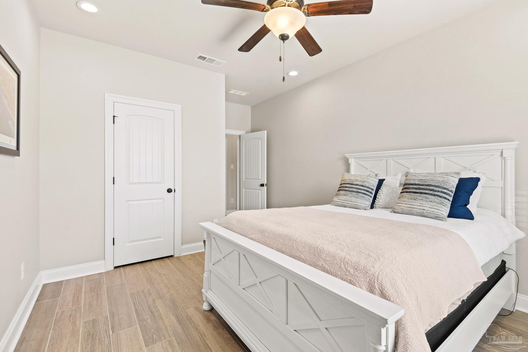 5912 Walter Franklin Road Pensacola, FL 32526 - Photo 35 of 51 a bedroom with a bed and wooden floor