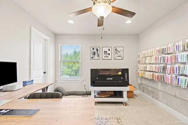 a work room with wooden floor and chandelier