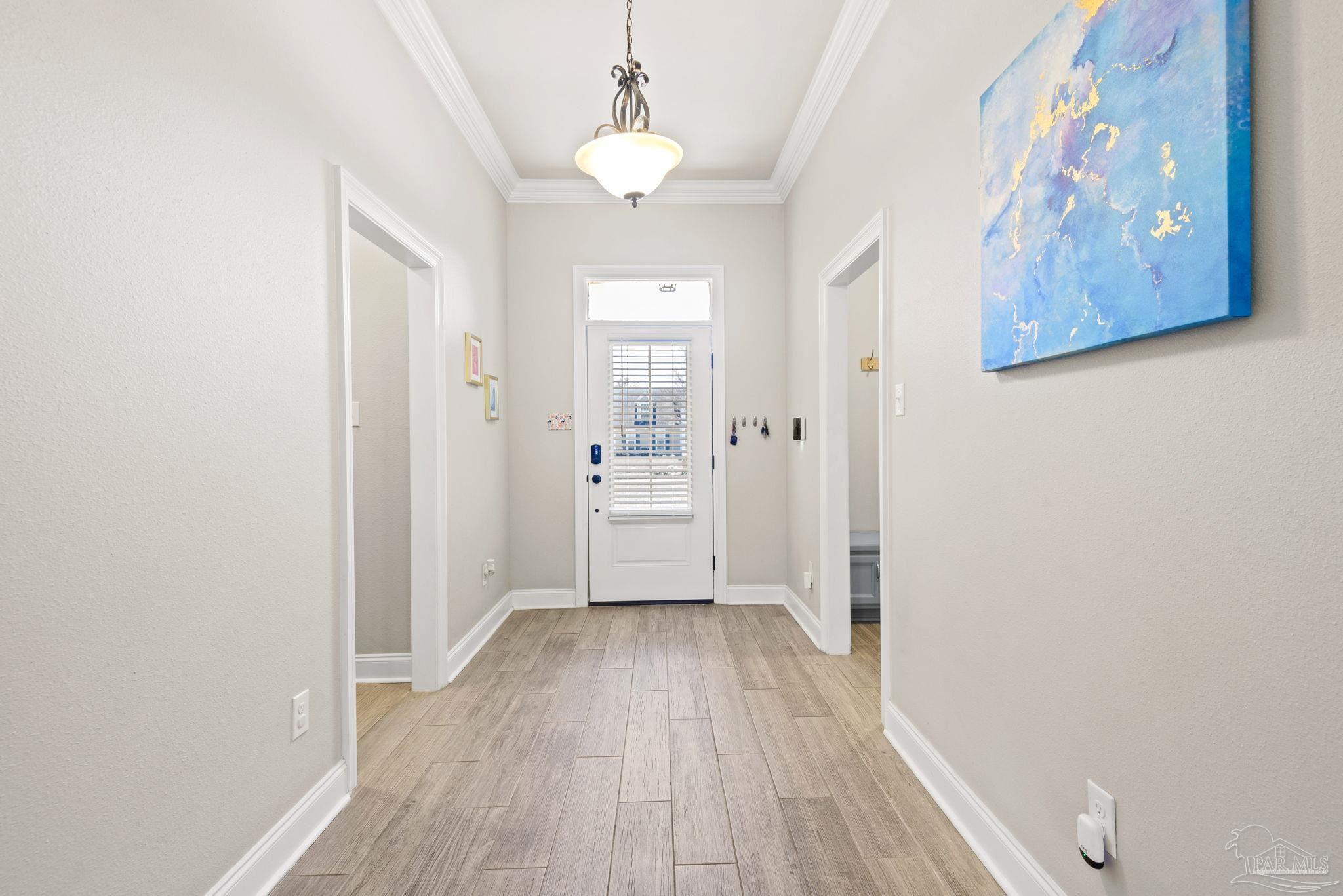 5912 Walter Franklin Road Pensacola, FL 32526 - Photo 10 of 51 a view of a hallway with wooden floor and a bathroom