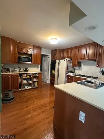 a kitchen with stainless steel appliances a refrigerator sink and stove
