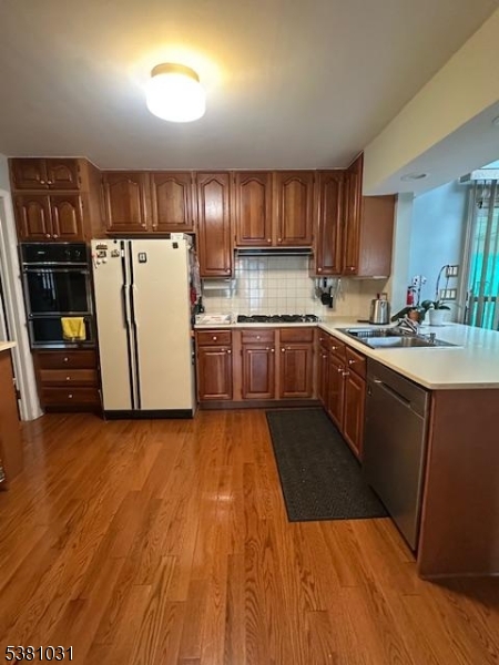 34 Brian Road West Caldwell, NJ 07006 - Photo 3 of 7 a kitchen with a sink a refrigerator and cabinets