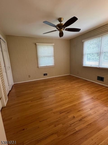 34 Brian Road West Caldwell, NJ 07006 - Photo 6 of 7 a view of an empty room with wooden floor and a window
