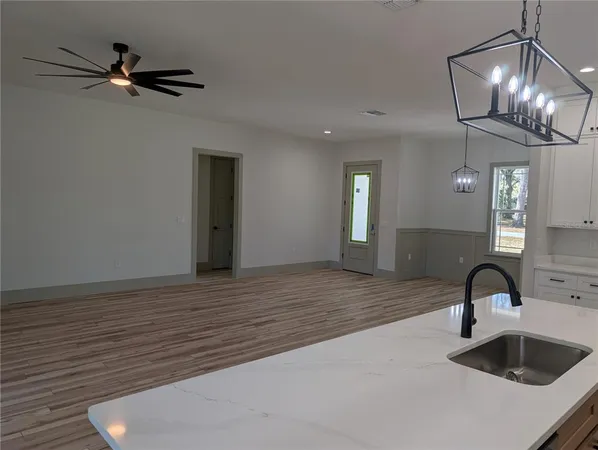 a view of a livingroom and kitchen countertops with wooden floor