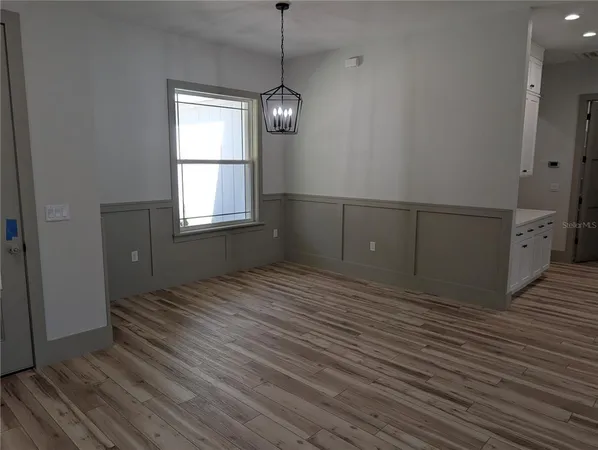 a view of a room with wooden floor and window