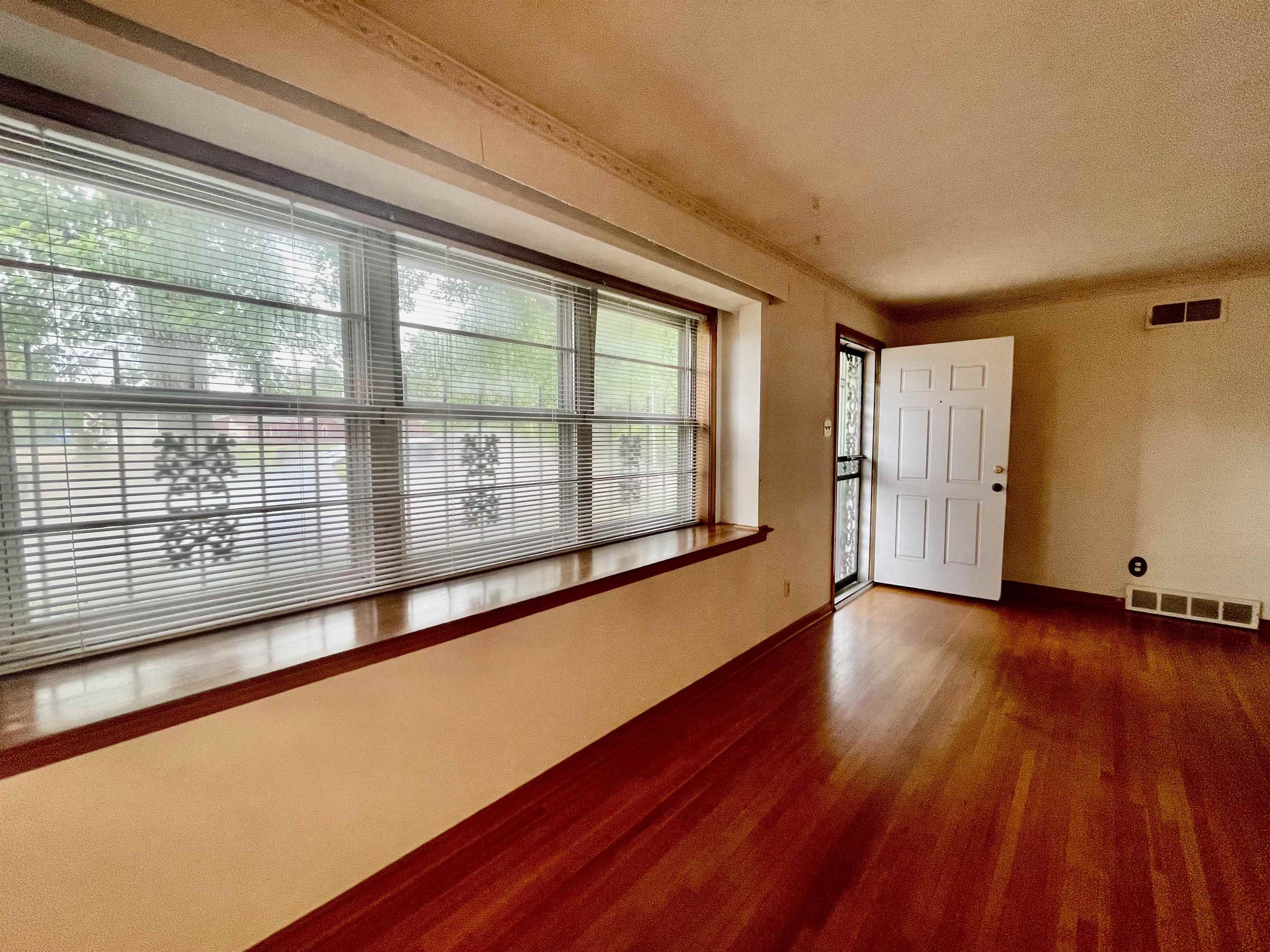 4857 Millbranch Road Memphis, TN 38116 - Photo 5 of 31 Empty room with dark wood-type flooring