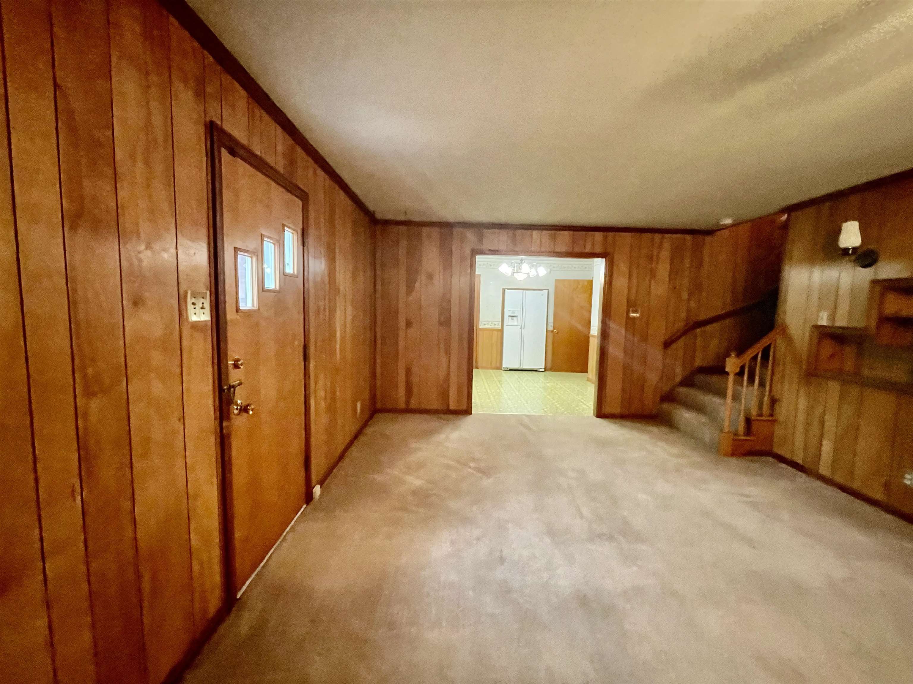 4857 Millbranch Road Memphis, TN 38116 - Photo 8 of 31 Spare room featuring light carpet and wooden walls