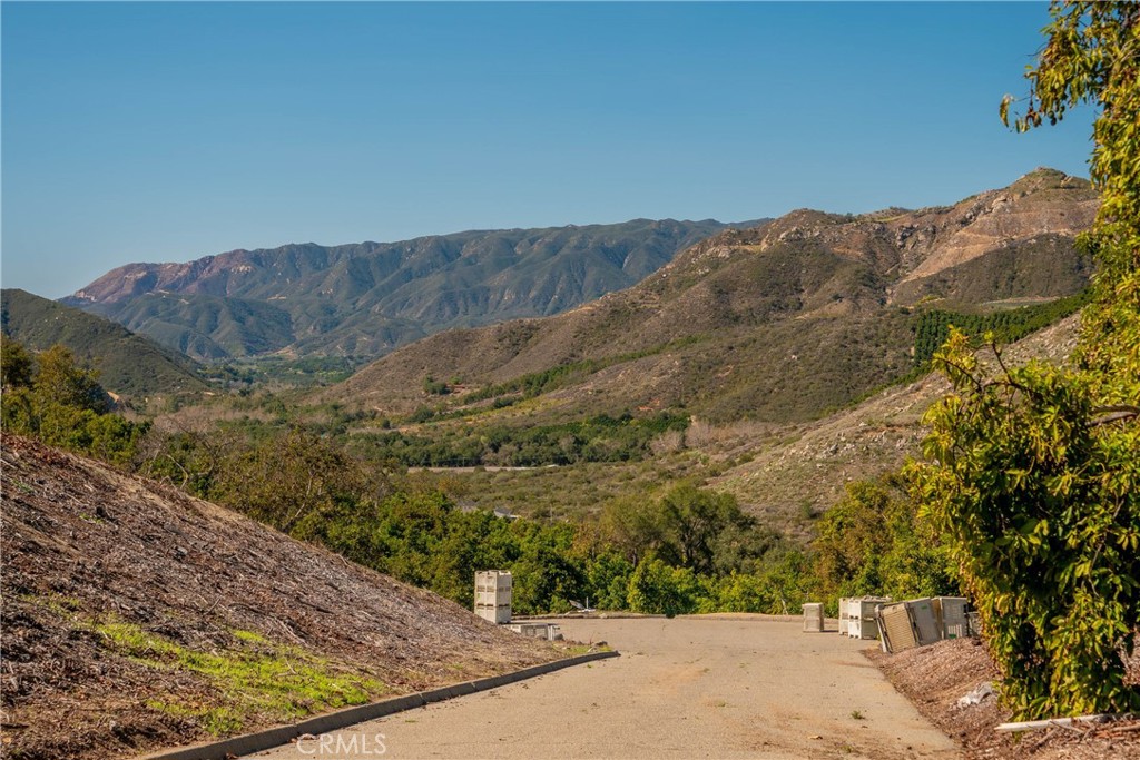 a view of a dry yard with mountains in the background