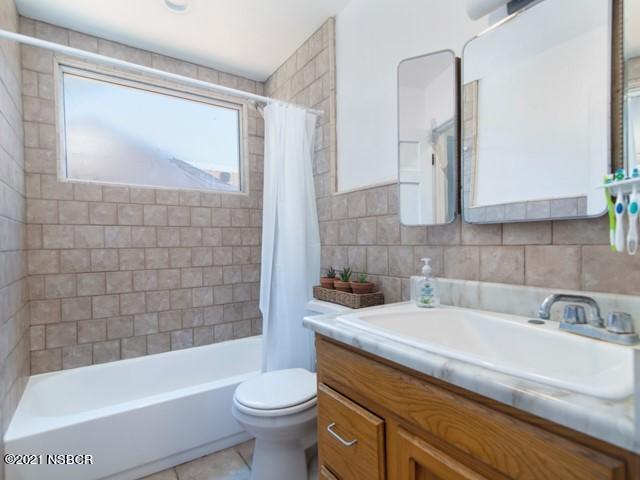 4061 Constellation Road Lompoc, CA 93436 - Photo 12 of 20 a bathroom with a sink a toilet and bathtub
