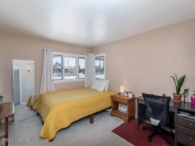 4061 Constellation Road Lompoc, CA 93436 - Photo 13 of 20 a bedroom with a bed and a desk
