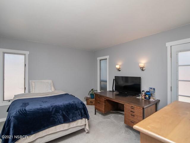 4061 Constellation Road Lompoc, CA 93436 - Photo 14 of 20 a bedroom with a bed and a flat screen tv