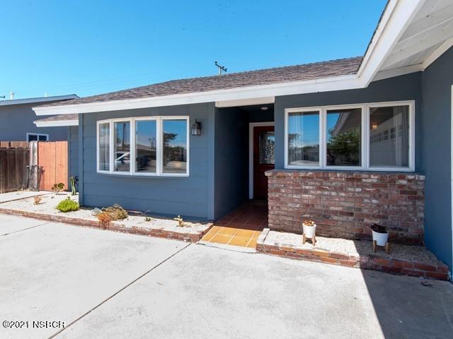 4061 Constellation Road Lompoc, CA 93436 - Photo 3 of 20 a view of a brick house with potted plants