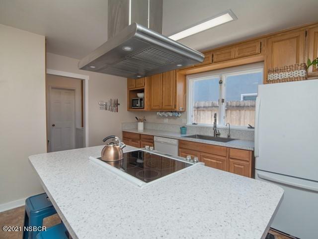 4061 Constellation Road Lompoc, CA 93436 - Photo 7 of 20 a kitchen with a table chairs sink and cabinets