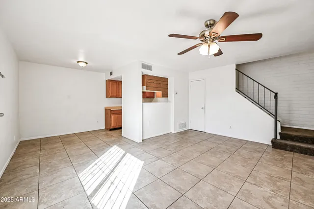 a view of a livingroom with a ceiling fan and window