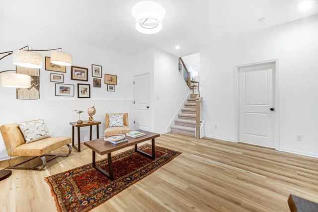 a living room with furniture and wooden floor