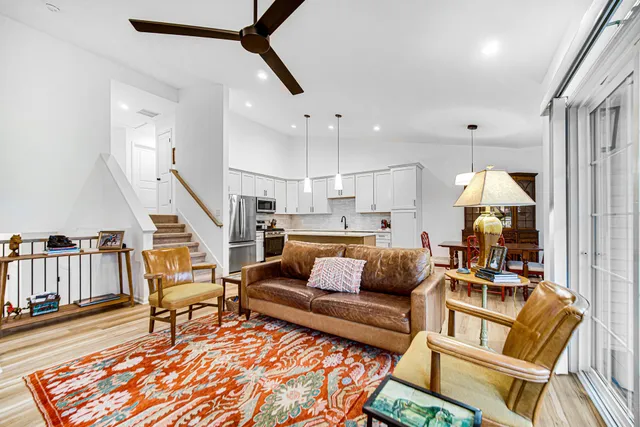 a living room with furniture and wooden floor