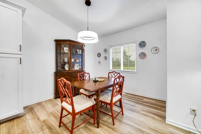 a view of a dining room with furniture wooden floor and chandelier