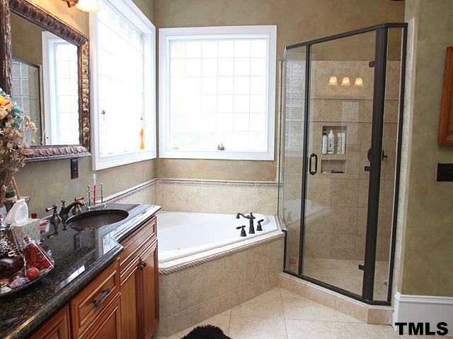 2105 Cowper Drive Raleigh, NC 27608 - Photo 14 of 25 a bathroom with a tub sink and mirror