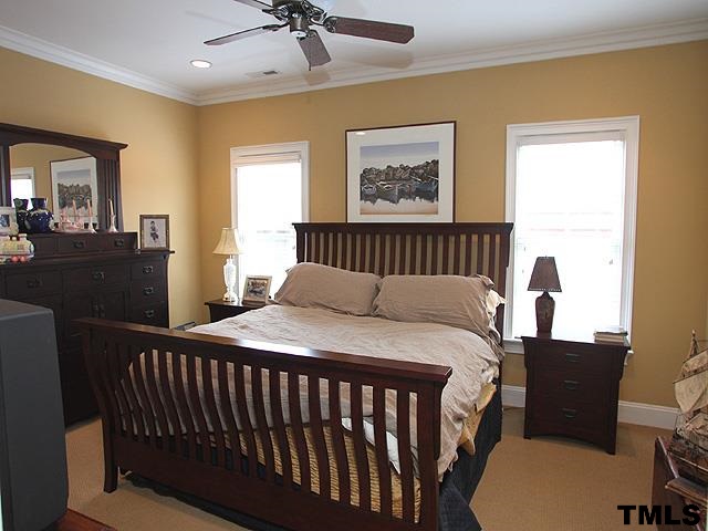 2105 Cowper Drive Raleigh, NC 27608 - Photo 17 of 25 a bedroom with a bed and wooden floor