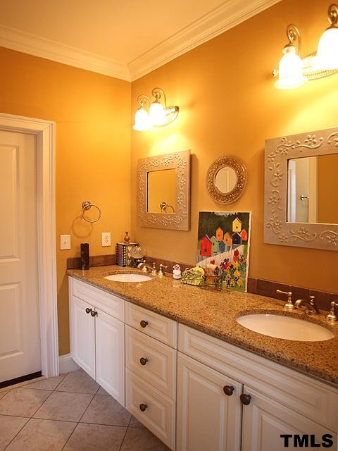 2105 Cowper Drive Raleigh, NC 27608 - Photo 18 of 25 a bathroom with a granite countertop sink and a mirror