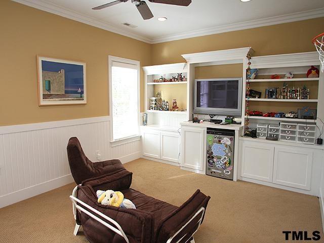 2105 Cowper Drive Raleigh, NC 27608 - Photo 20 of 25 a living room with furniture a flat screen tv and a window