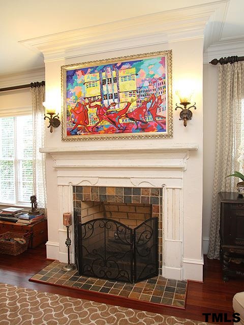 2105 Cowper Drive Raleigh, NC 27608 - Photo 21 of 25 a living room with furniture a fireplace and a window