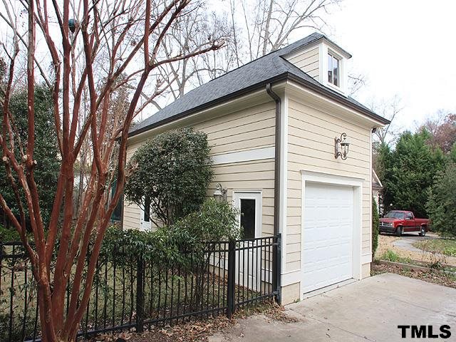 2105 Cowper Drive Raleigh, NC 27608 - Photo 24 of 25 a view of a white house with a small yard and wooden fence