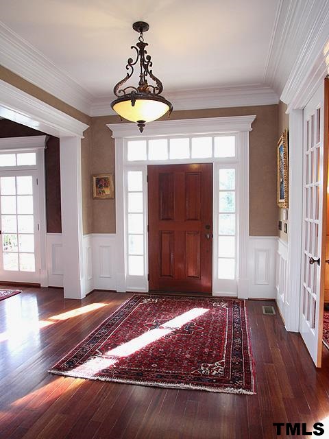 2105 Cowper Drive Raleigh, NC 27608 - Photo 4 of 25 a view of a livingroom with wooden floor and door