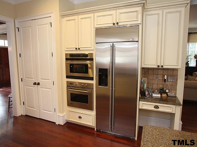 2105 Cowper Drive Raleigh, NC 27608 - Photo 8 of 25 a kitchen with stainless steel appliances a refrigerator and a stove top oven