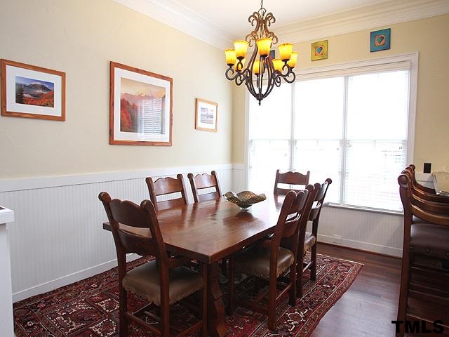 2105 Cowper Drive Raleigh, NC 27608 - Photo 9 of 25 a view of a dining room with furniture a chandelier and a window