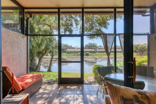 a living room with couch and a floor to ceiling window