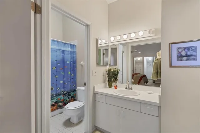 a bathroom with a toilet a sink and a mirror