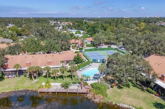 an aerial view of residential houses with outdoor space and swimming pool