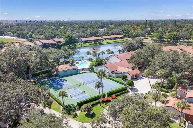 an aerial view of residential houses with outdoor space and river