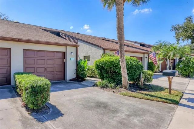 a view of a house with a yard and garage