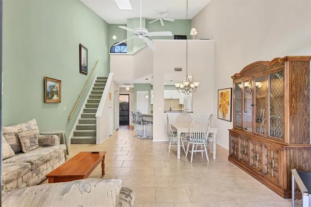 a living room with furniture and a chandelier