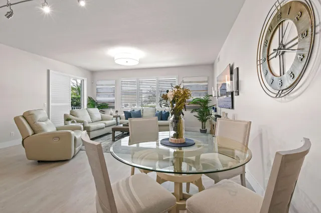 a living room with furniture potted plant and a large window