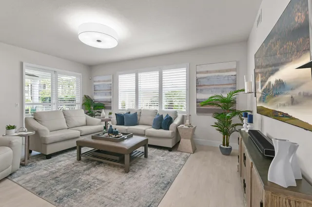 a bedroom with a large bed couch and window