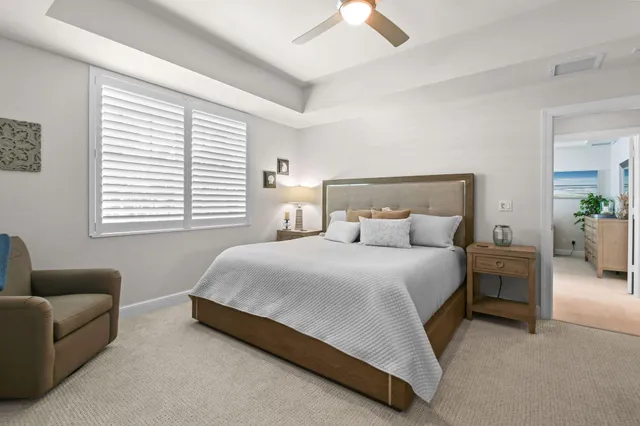 a spacious bathroom with a tub sink and mirror