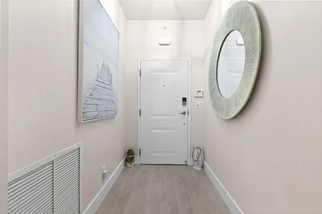 a kitchen with stainless steel appliances kitchen island granite countertop a table chairs and a refrigerator