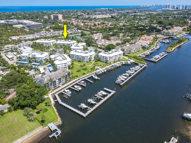 a view of a swimming pool with a bench in front of house
