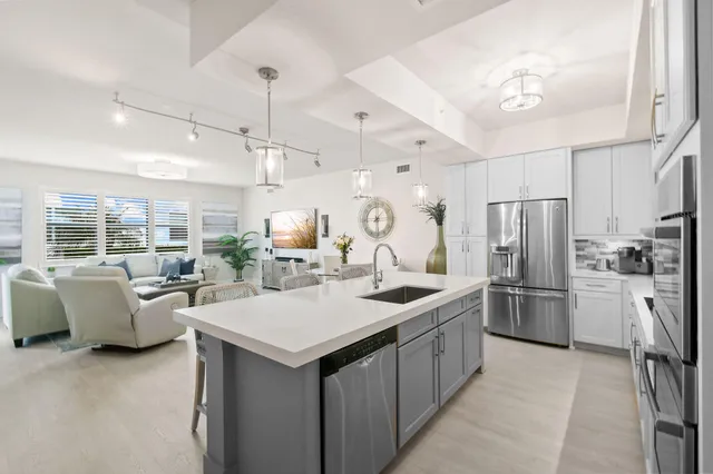a living room with furniture and a chandelier