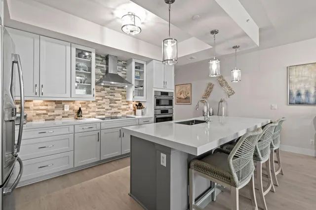 a living room with furniture kitchen view and a table
