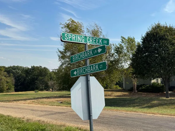 a view of a sign board with yard