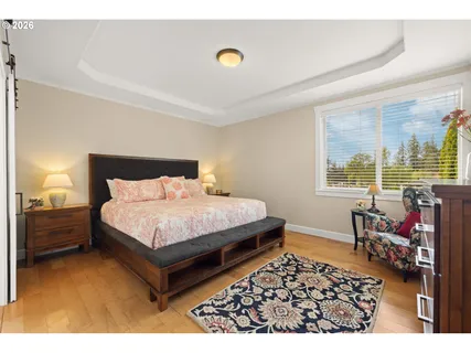 a bedroom with a bed and a night stand