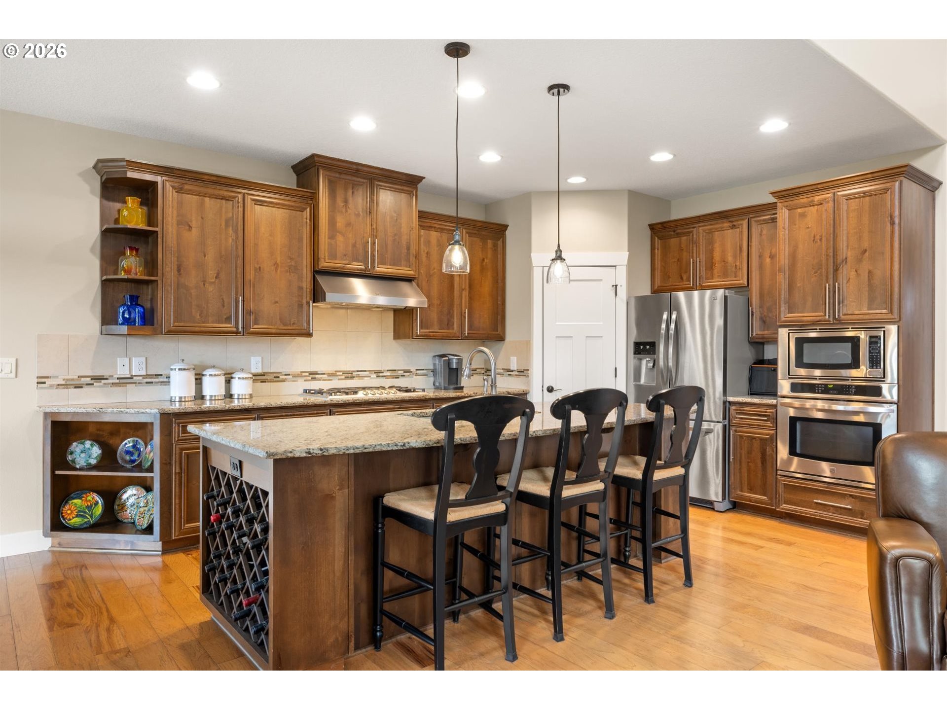 1274 South 15th Way Ridgefield, WA 98642 - Photo 10 of 46 a kitchen with stainless steel appliances kitchen island granite countertop a table chairs sink and cabinets