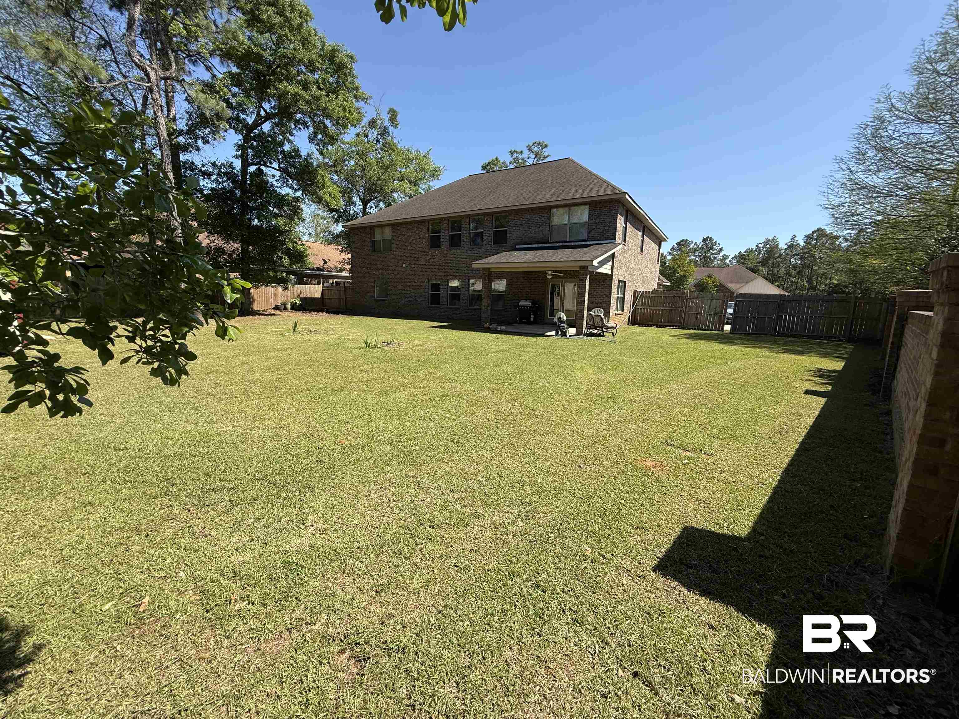 9023 Krystal Ridge Court Daphne, AL 36526 - Photo 37 of 41 Rear view of property featuring a patio, a fenced backyard, and brick siding