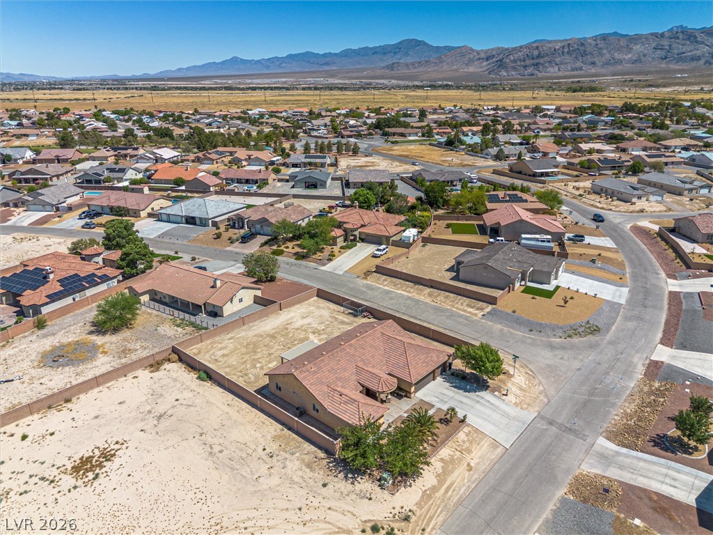 6720 Stubblefield Drive Pahrump, NV 89061 - Photo 38 of 51 An aerial perspective reveals a desert community nestled against a mountain backdrop.