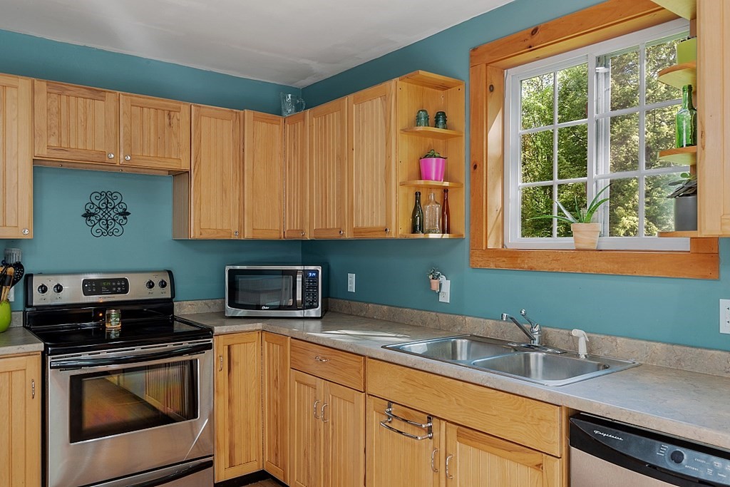 540 Royalston Road Phillipston, MA 01331 - Photo 11 of 38 a kitchen with granite countertop a sink a stove and cabinets